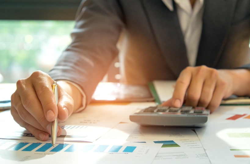 A person with a calculator and pencil