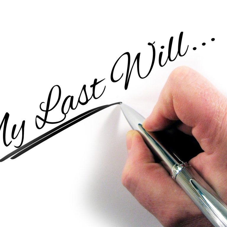 hand with pen and writing that says My last will....