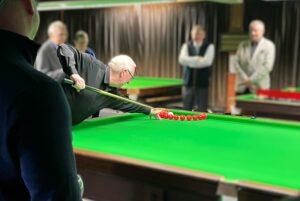 1985 World Snooker Champion Dennis Taylor performing a trick shot