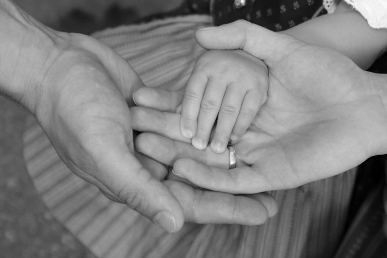 Parents in Cheshire holding hands after appointing guardians in will