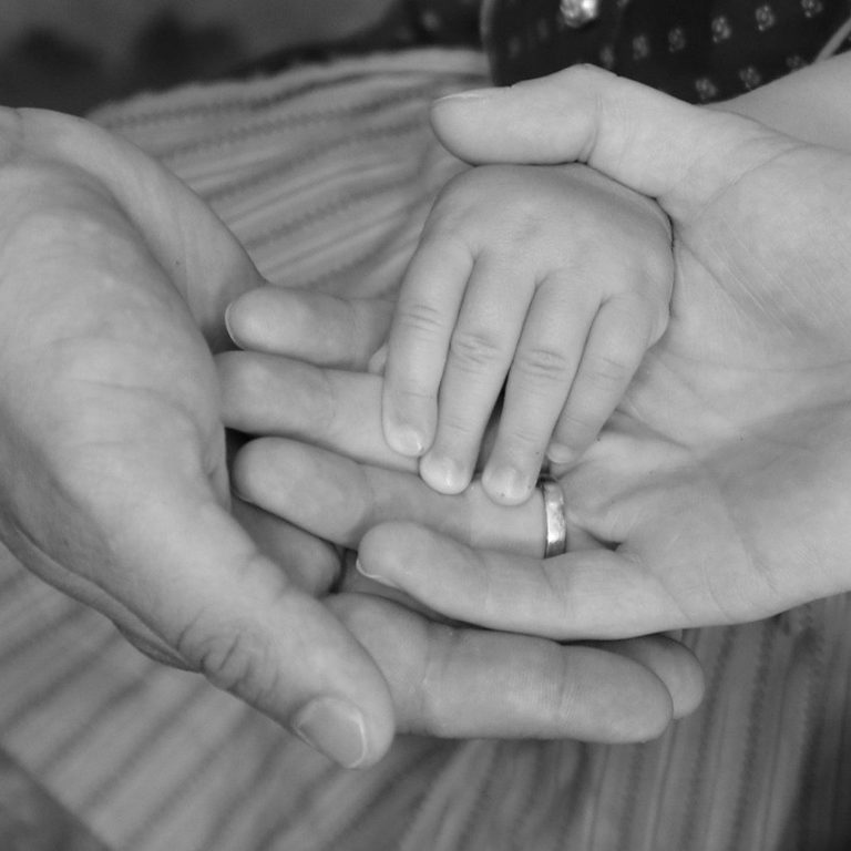 Parents in Cheshire holding hands after appointing guardians in will