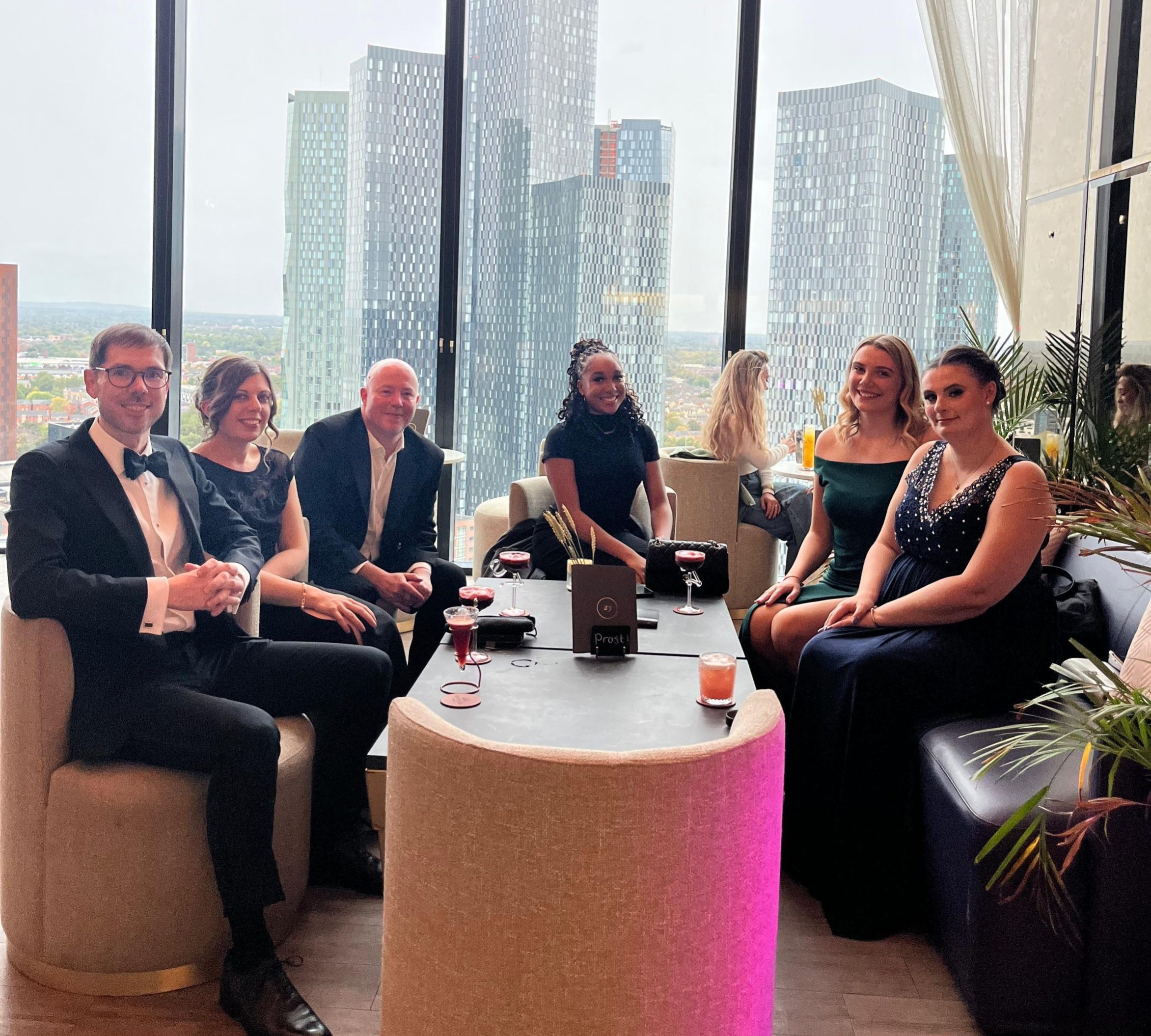 Spall Clark team at Cloud 23 with the Manchester skyline behind them